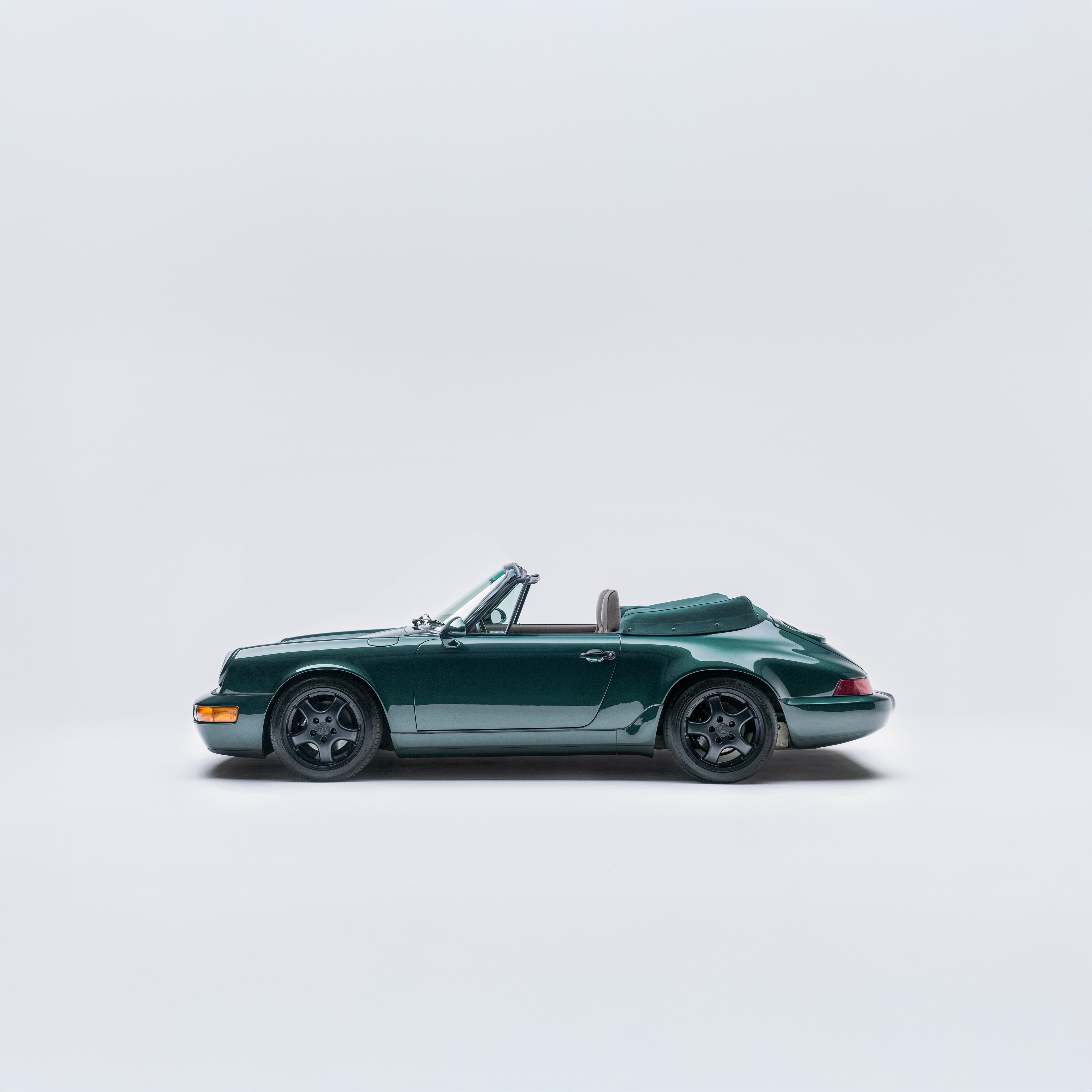 Porsche 964 Carrera 4 Cabriolet in Dark Green Metallic — side profile